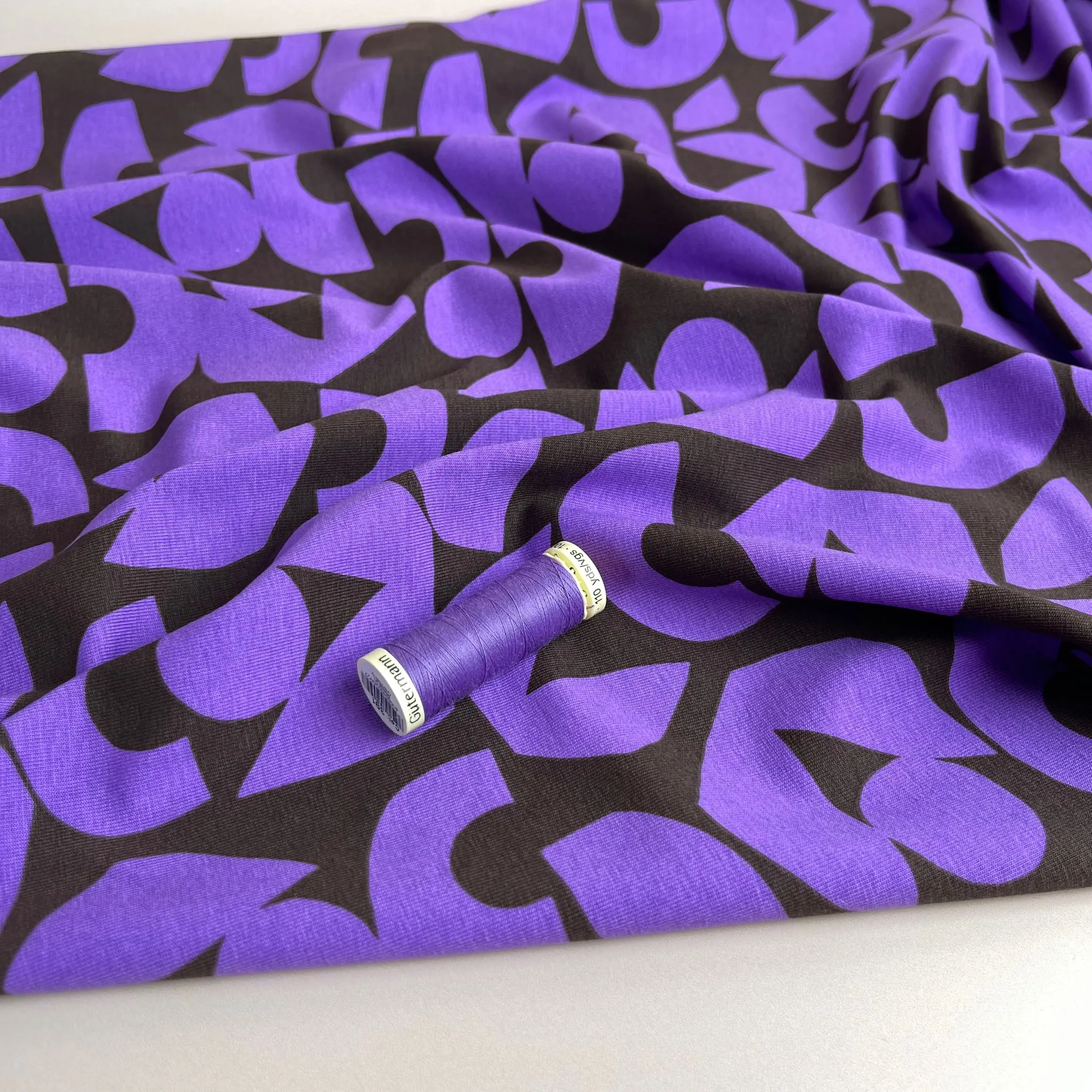 Purple Shapes on Brown Combed Cotton Jersey Fabric